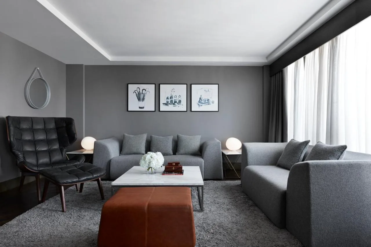 a living room with a couch and a chair at Kimpton Blythswood Square Hotel & Spa by IHG in Glasgow